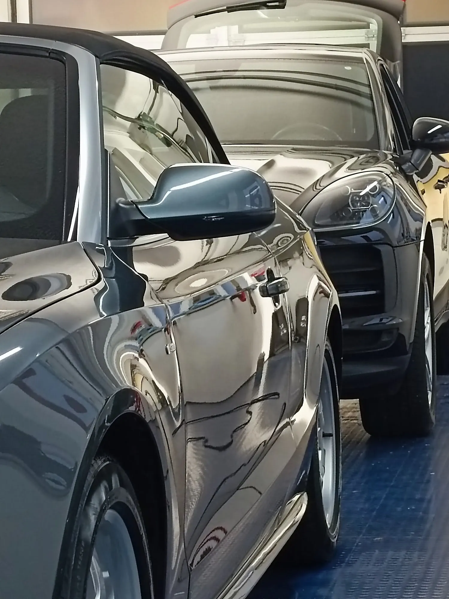 Zwei polierte schwarze Fahrzeuge nebeneinander in der Werkstatt